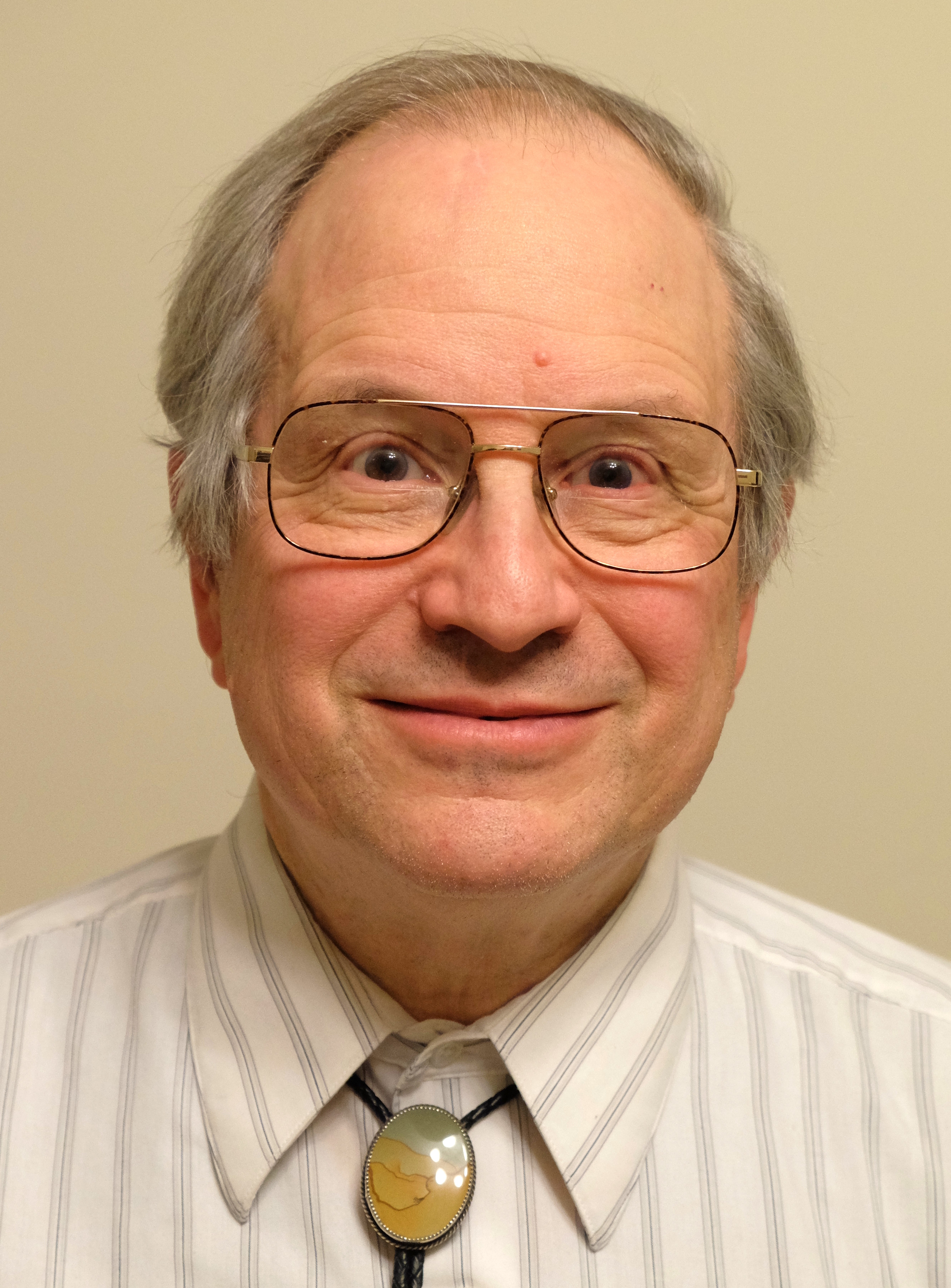 A picture of a smiling Gerald Jay Sussman, who is wearing
              glasses and a blue plaid shirt.